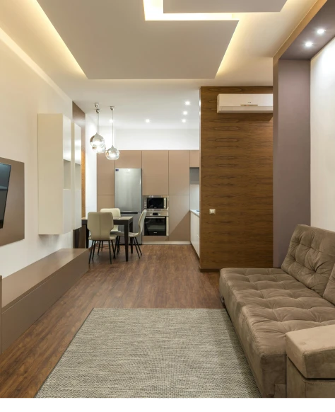 a living room with a couch and a kitchen.