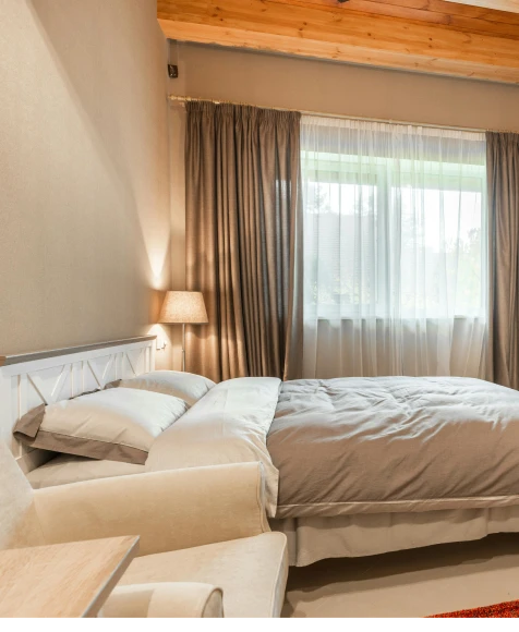 a bed with a lamp and a window.